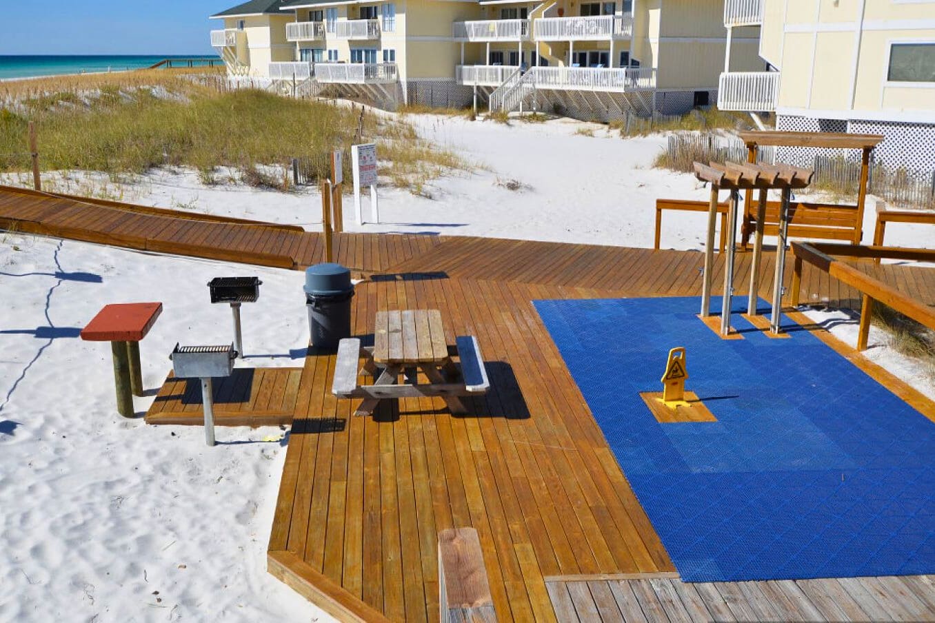 Outdoor picnic and grilling area at Sandpiper Cove Resort, surrounded by sugar-white dunes—perfect for casual cookouts, relaxed gatherings, and coastal downtime just steps from the beach.