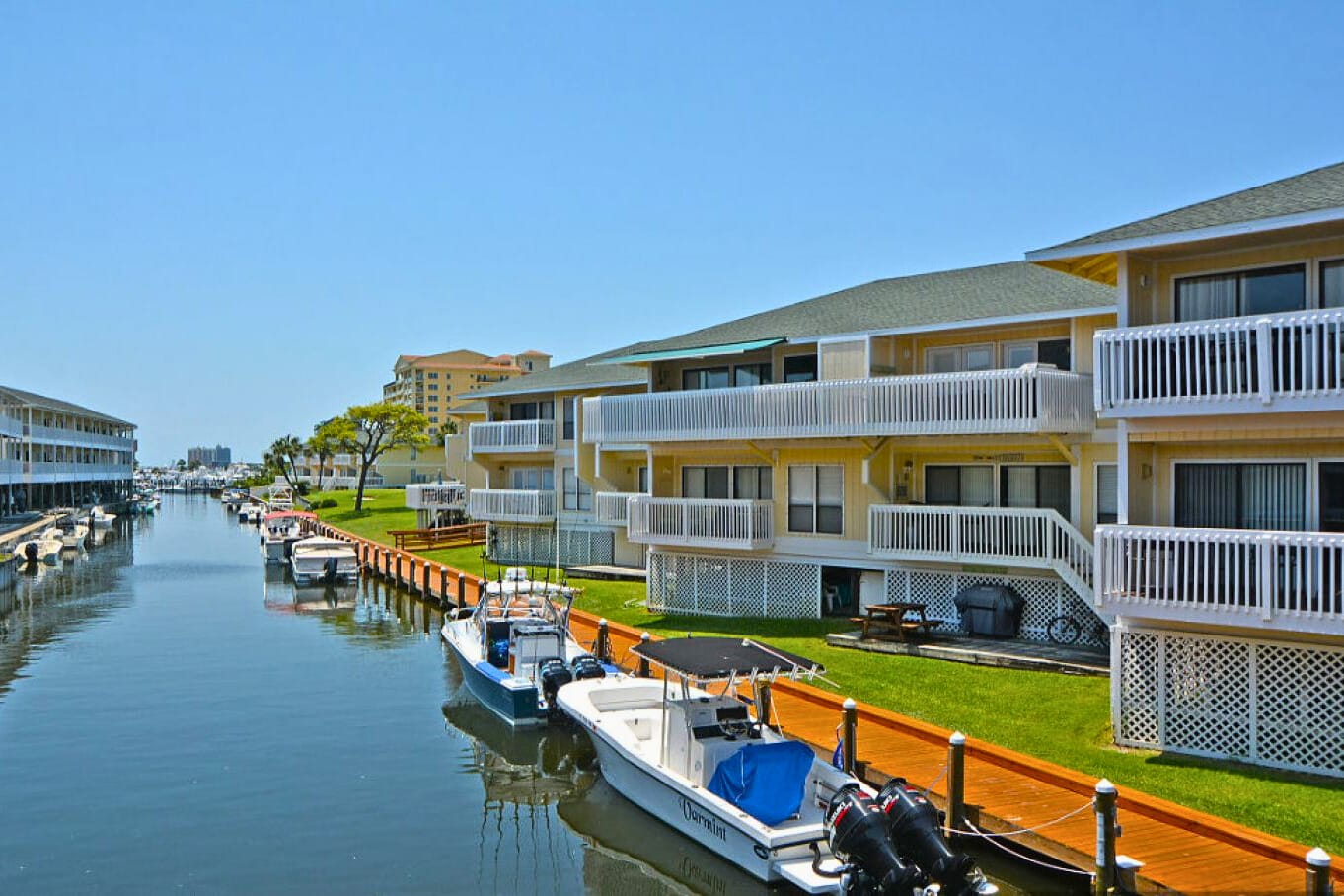 Scenic marina at Sandpiper Cove Resort with boat slips along calm harbor waters—ideal for boating and fishing. Call the marina directly for slip availability, rates, and details.