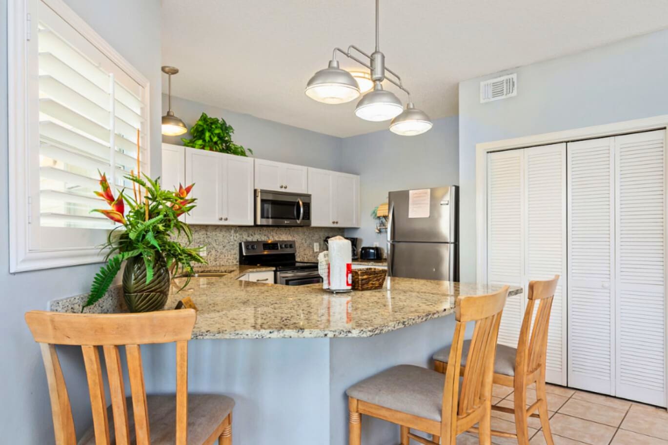 Bright Coastal Kitchen with Granite Counters & Breakfast Bar Seating