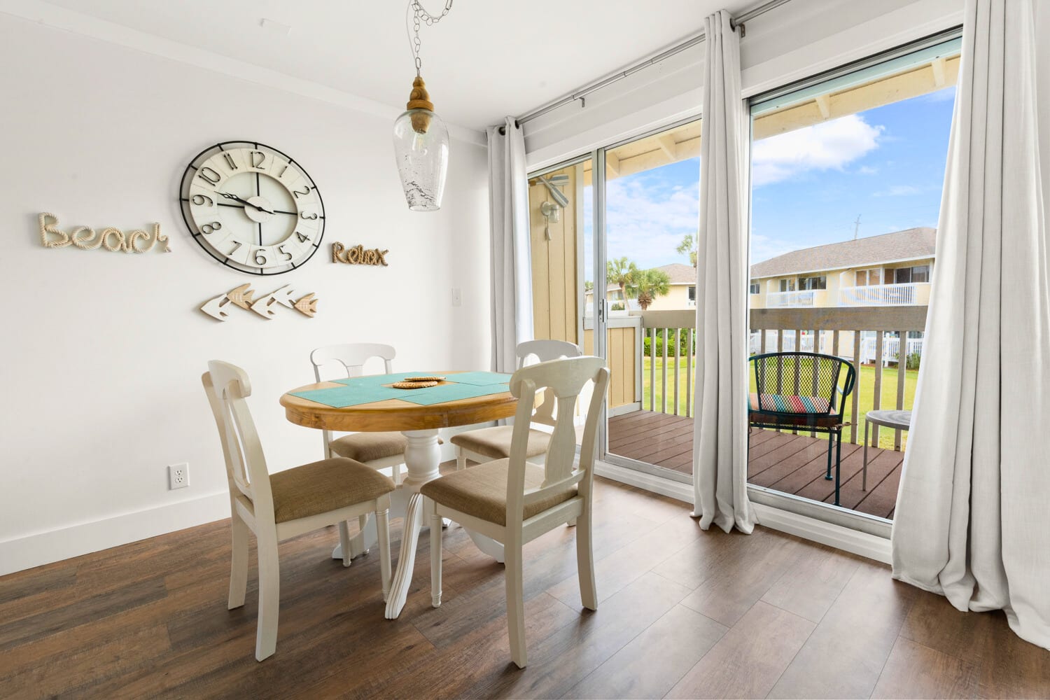 Gather around your charming dining table where beach-themed décor and warm natural light create the perfect setting for morning coffee or evening meals.