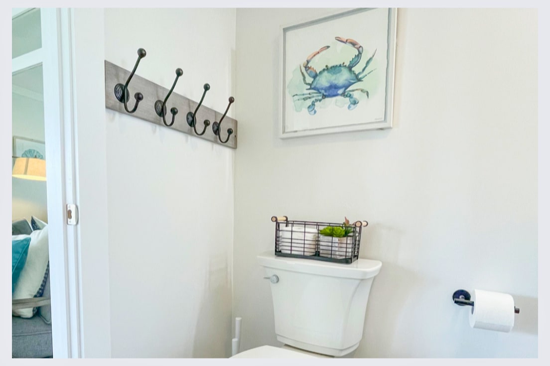 Your private bathroom features thoughtful coastal touches and convenient hooks for your towels and belongings.