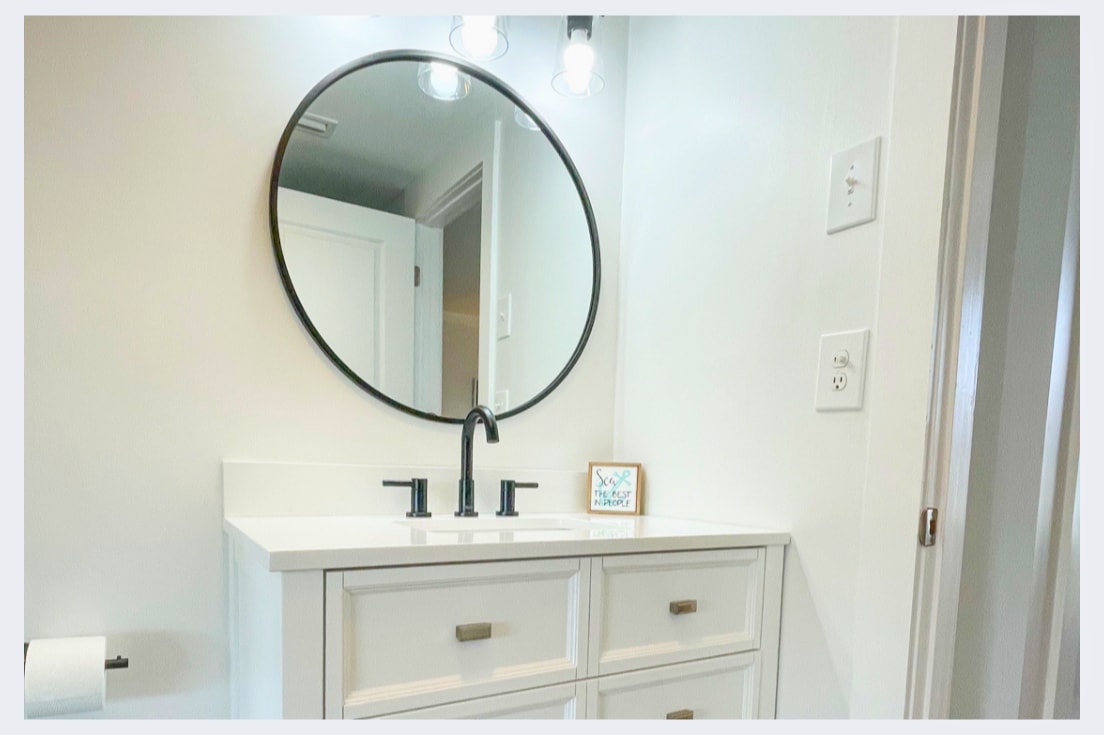 Your bright bathroom vanity offers clean lines and ample storage for your morning routine.