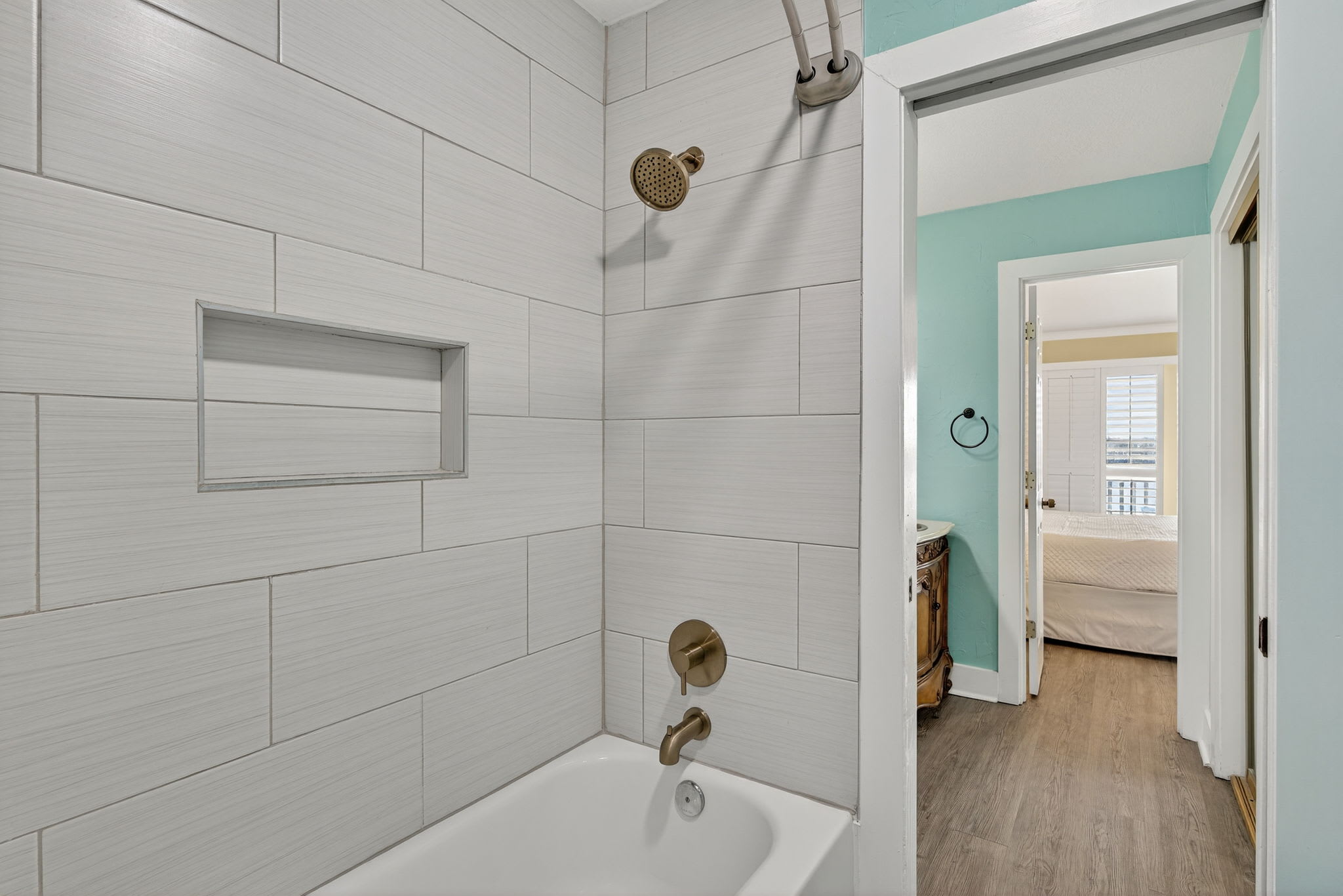 Step into your private bathroom featuring a relaxing tub-shower combo with modern fixtures and soothing neutral tones, connecting seamlessly to your bedroom retreat.