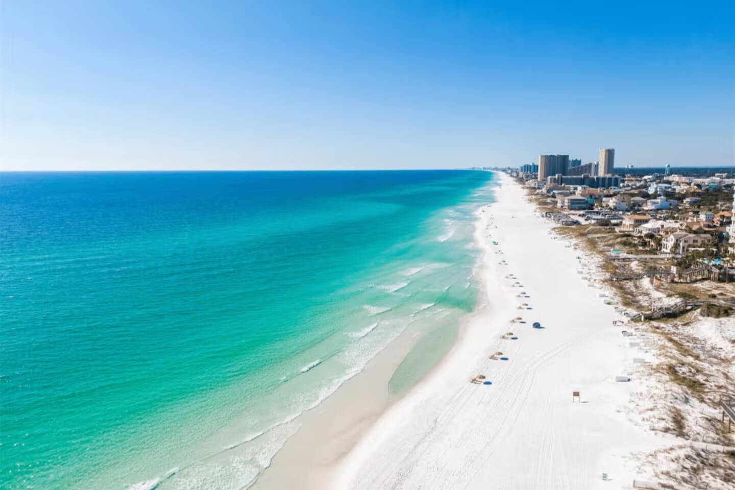 Powder-white sand meets crystal-clear waves—your perfect beach day starts on this stunning shoreline.