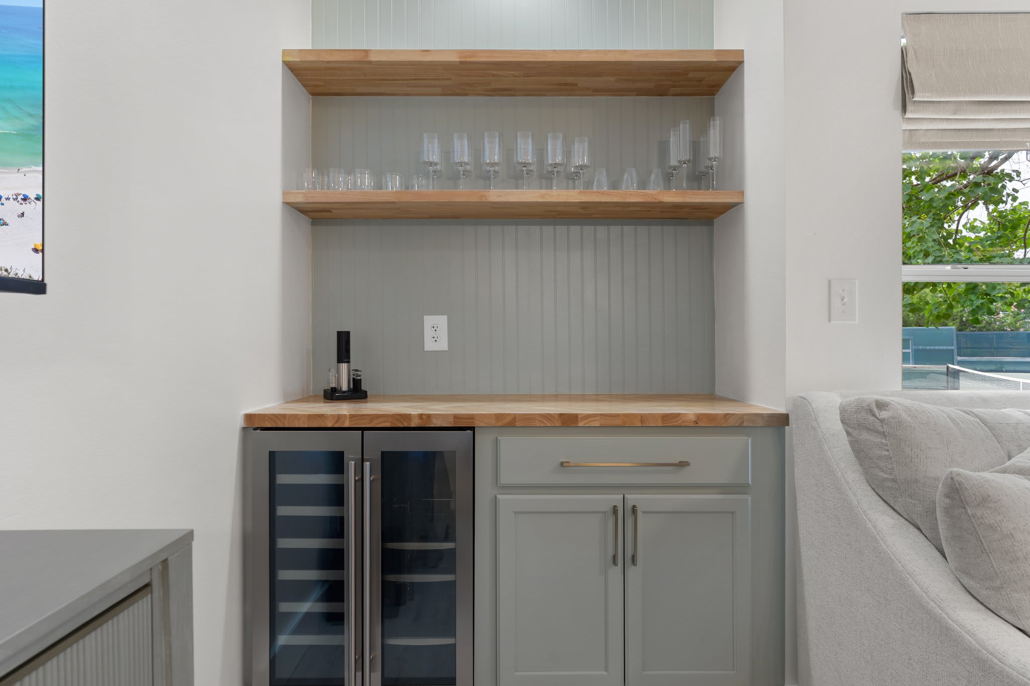 Chic built-in bar with wood accents and wine cooler—perfect for relaxing with your favorite vintage.