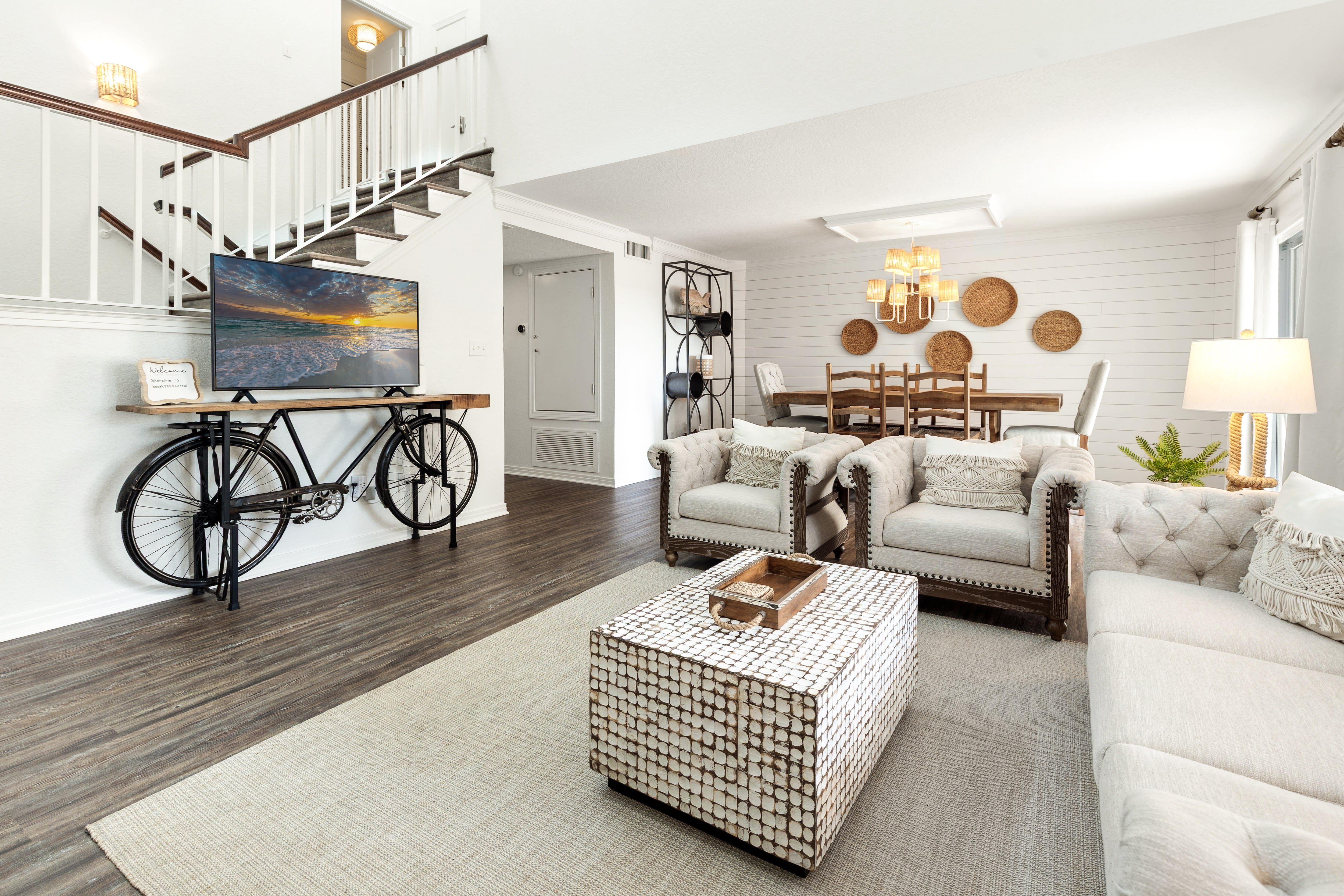 Unwind in your stylish living space where modern comfort meets coastal charm, complete with plush seating and thoughtful design touches.