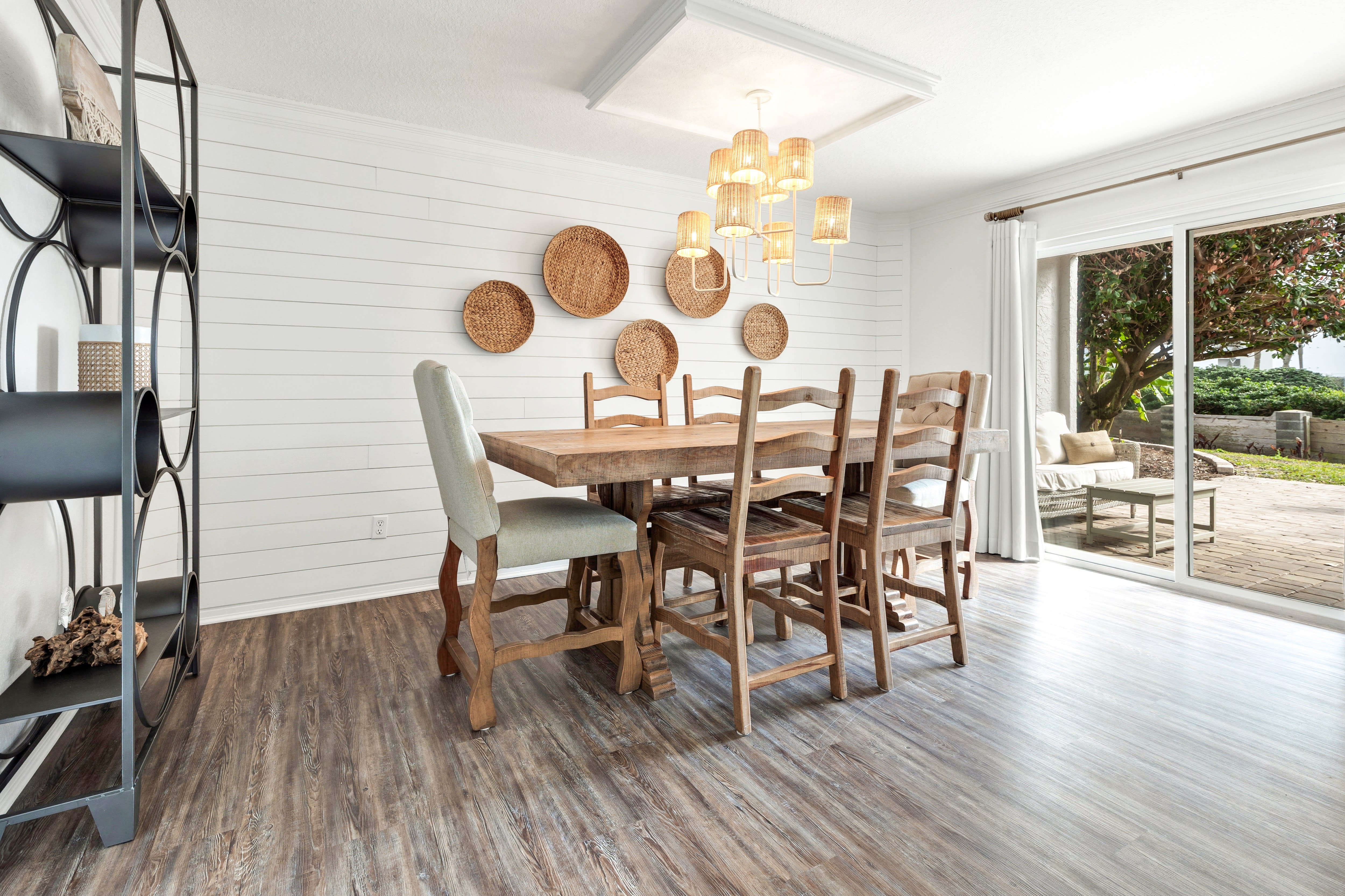 Gather around this gorgeous rustic dining table where warm woven accents and coastal charm create the perfect atmosphere for memorable meals with loved ones.