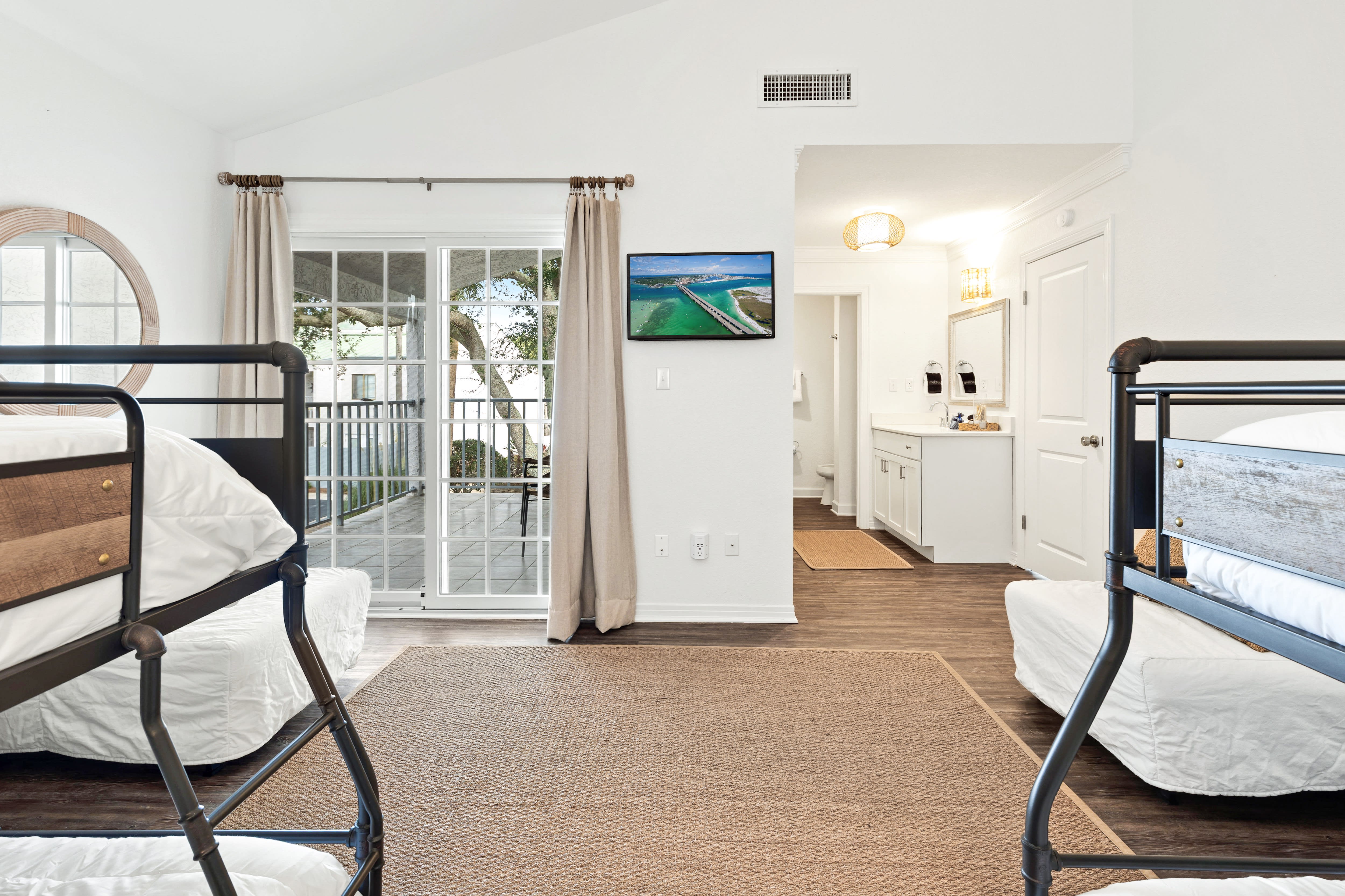 Relax in your comfortable bunk room with crisp linens, natural light, and modern amenities perfect for a restful stay.