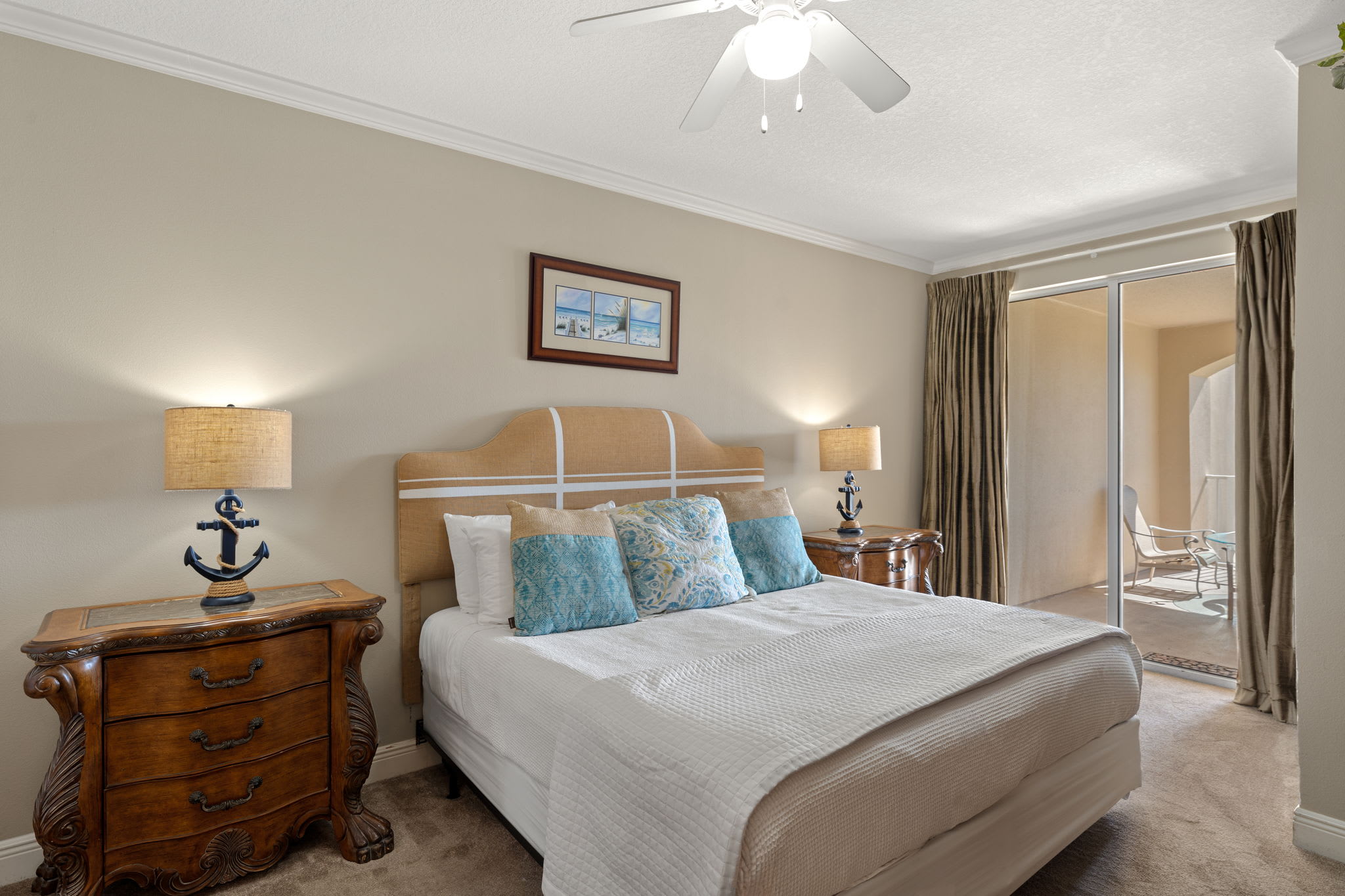 Rest peacefully in the coastal-themed bedroom with anchor-detailed lamps, plush linens, and a private balcony for morning coffee.