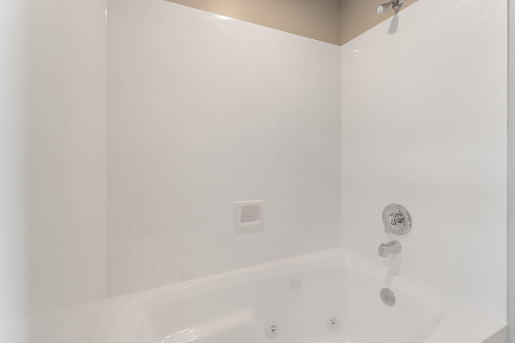 Slip into this pristine bathtub for a relaxing soak after your adventures, with clean white surroundings.