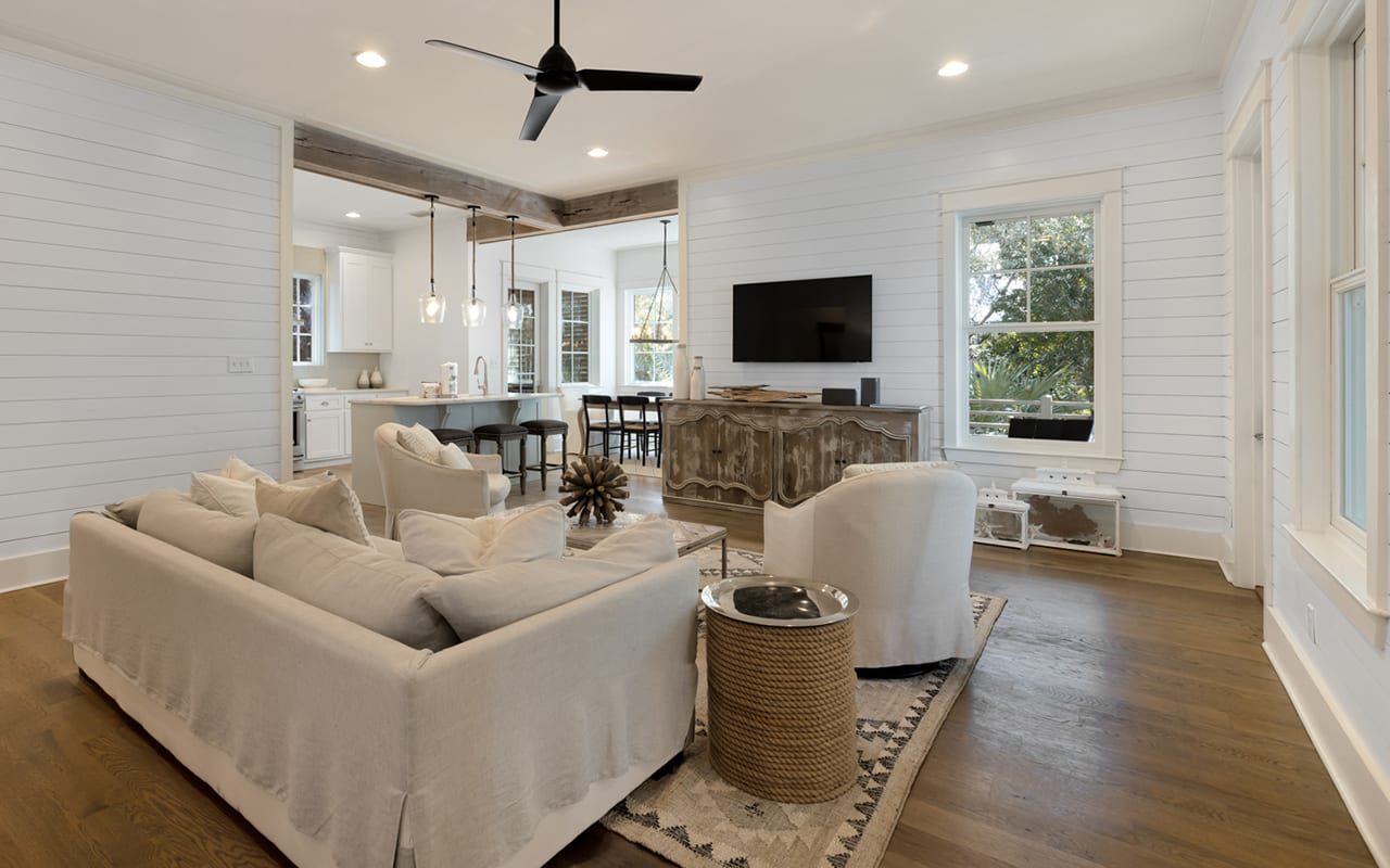 Relax in your bright, open living space with comfy seating, modern kitchen, and charming shiplap walls that create the perfect coastal retreat.