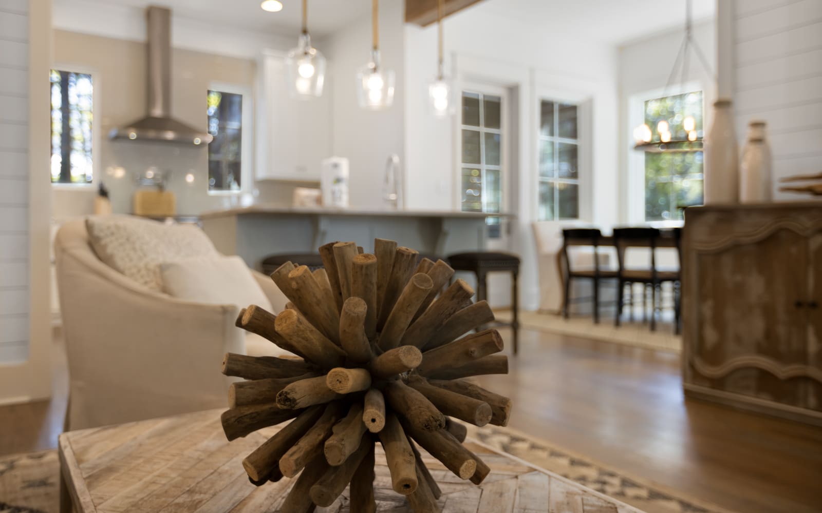 Your bright, open-concept living space seamlessly blends comfort and style with sleek pendant lighting, cozy seating, and a modern kitchen perfect for memorable stays.