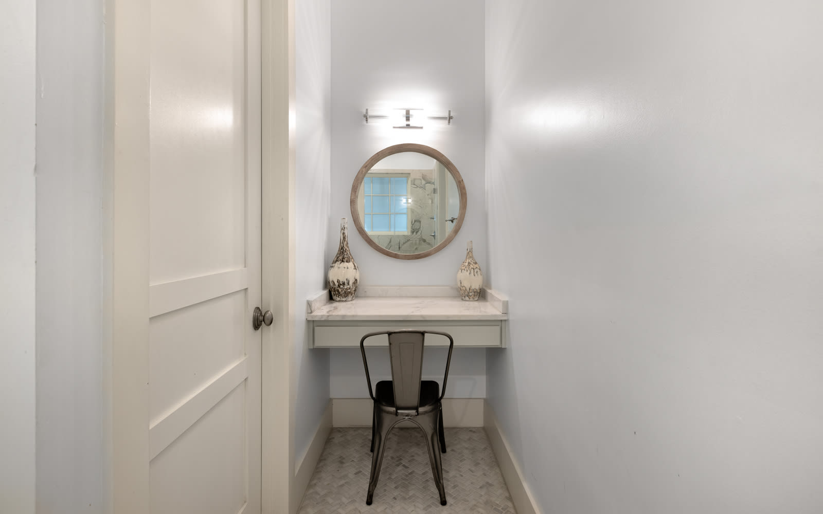 Your private vanity nook features elegant lighting and a cozy chair—perfect for morning routines or evening touch-ups.