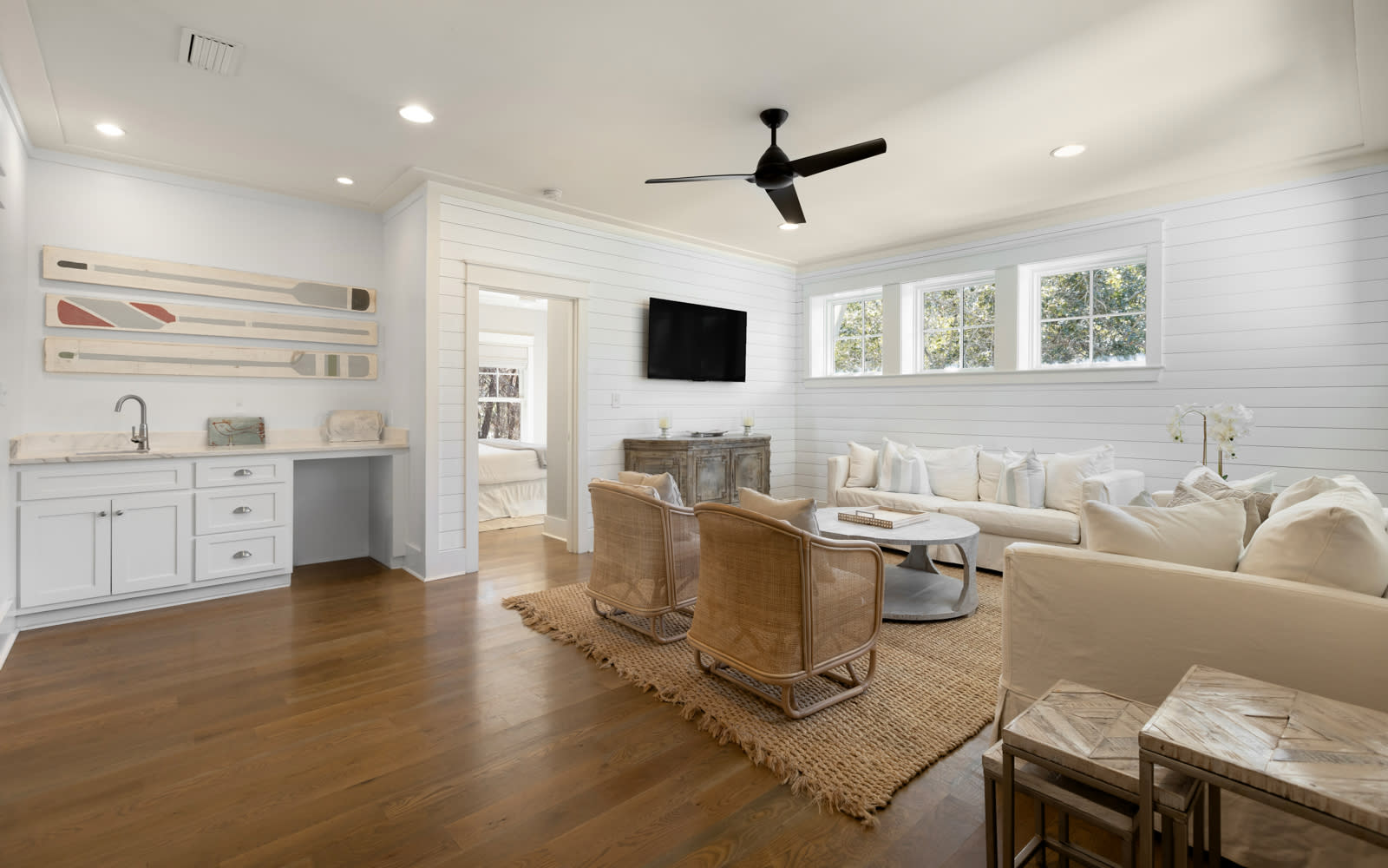 Sink into plush cream seating while natural light streams through large windows, creating your perfect space to unwind and connect.
