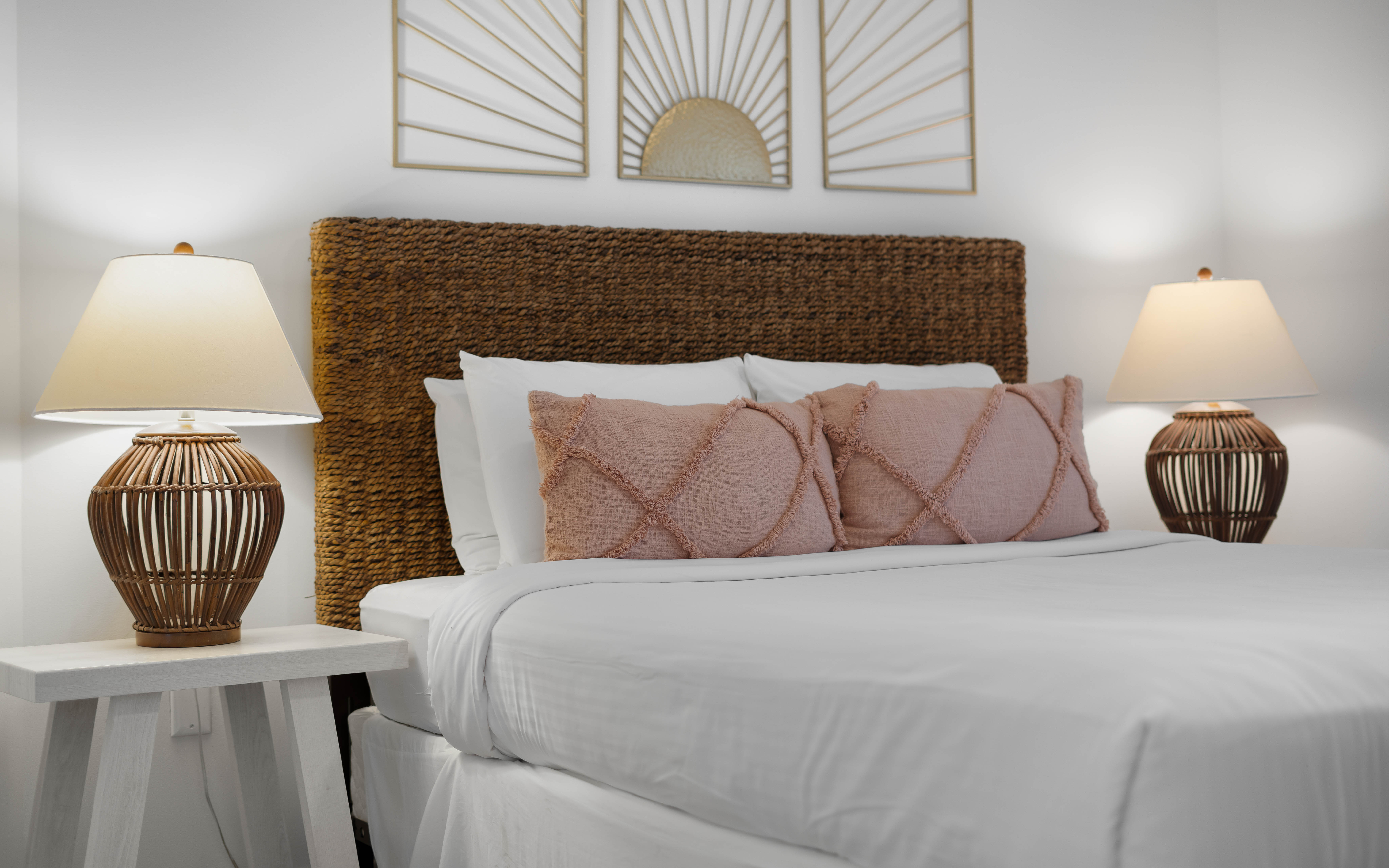 Sink into crisp white linens and soft textures in your beautifully appointed bedroom, where warm lighting creates the perfect ambiance for restful nights.