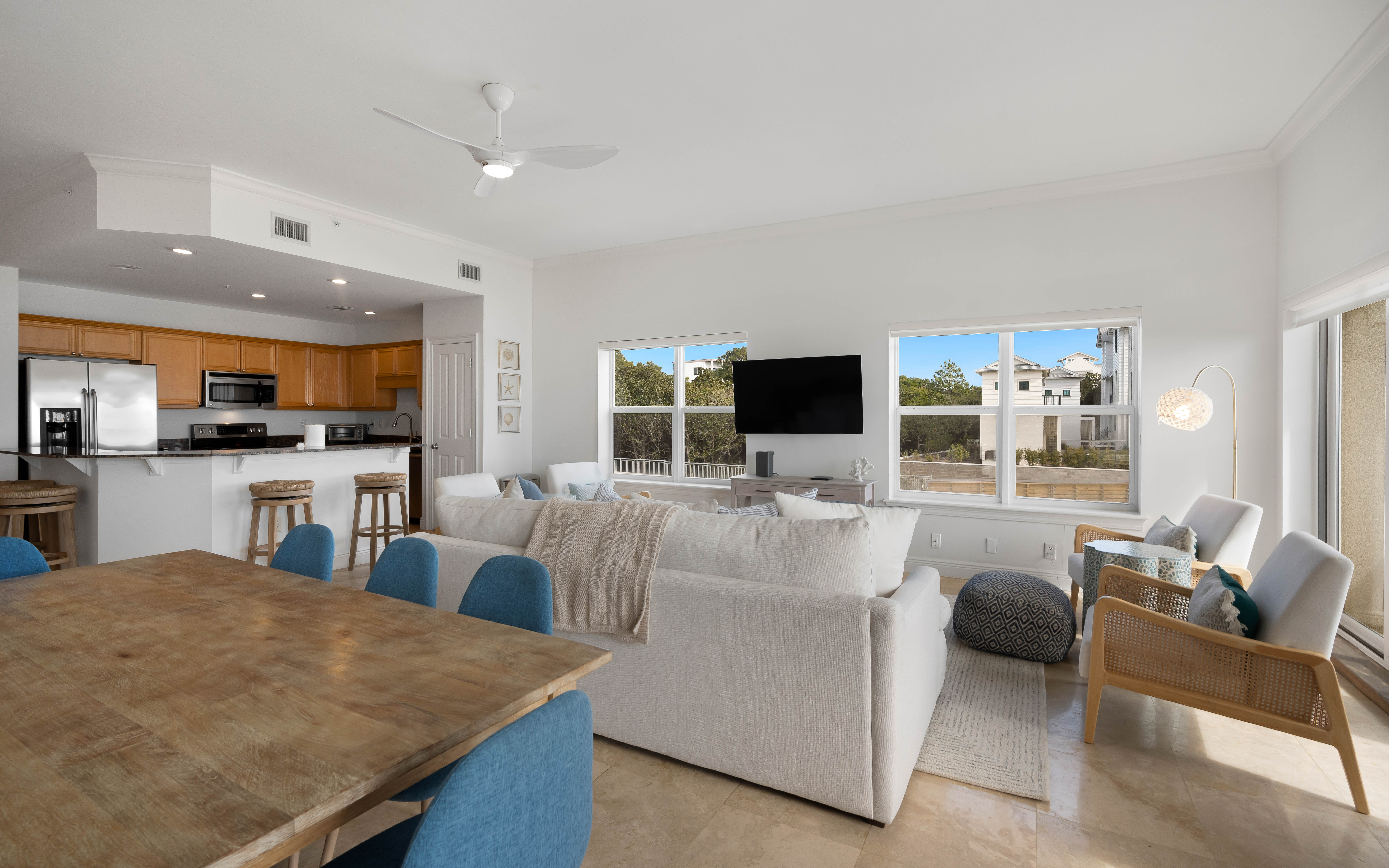 Your open-concept living space flows effortlessly from kitchen to lounge, with natural light streaming through large windows and comfortable seating for relaxation.