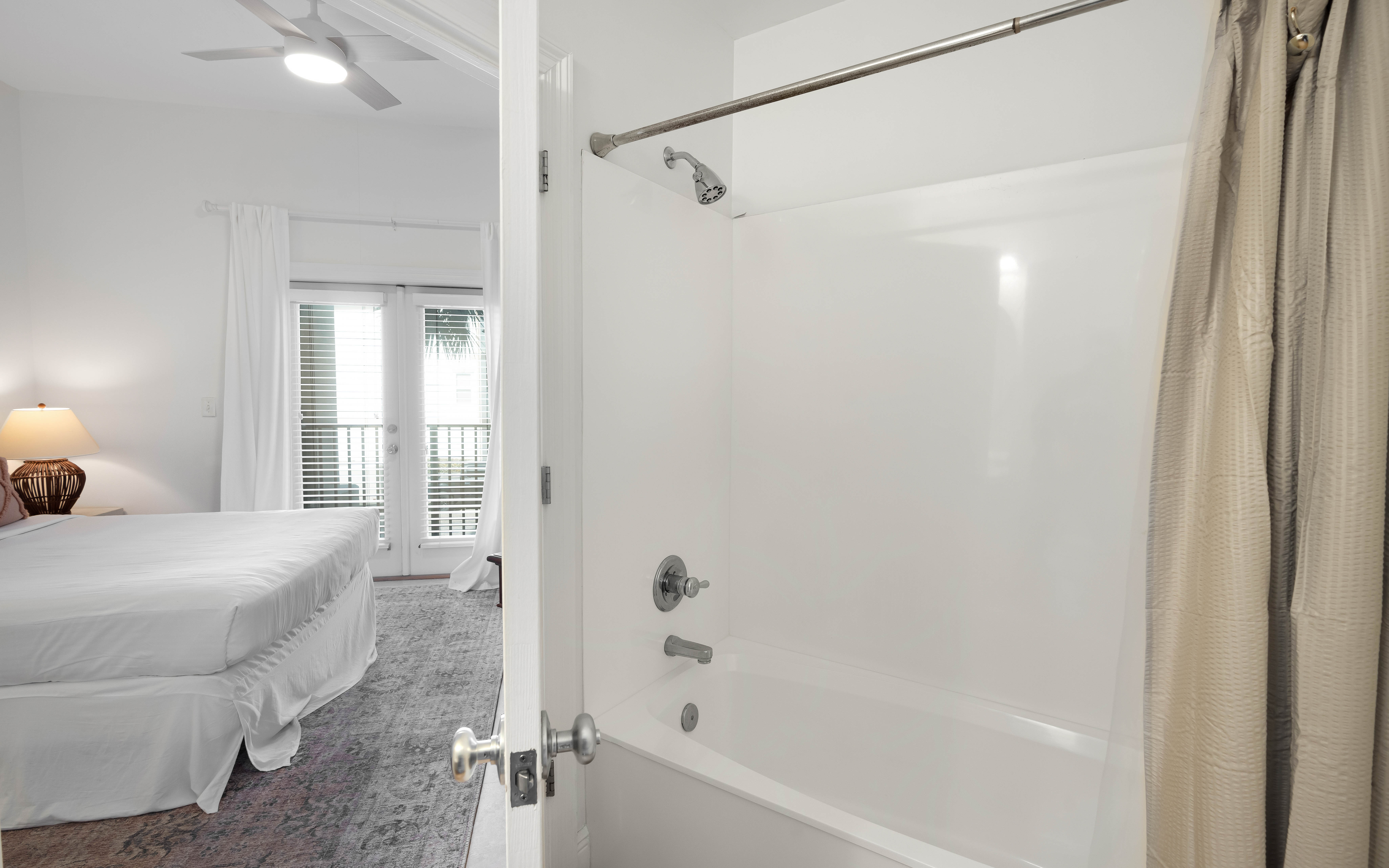 Step into your private spa-like bathroom with pristine white surfaces and a full tub-shower combo, perfect for unwinding after exploring.