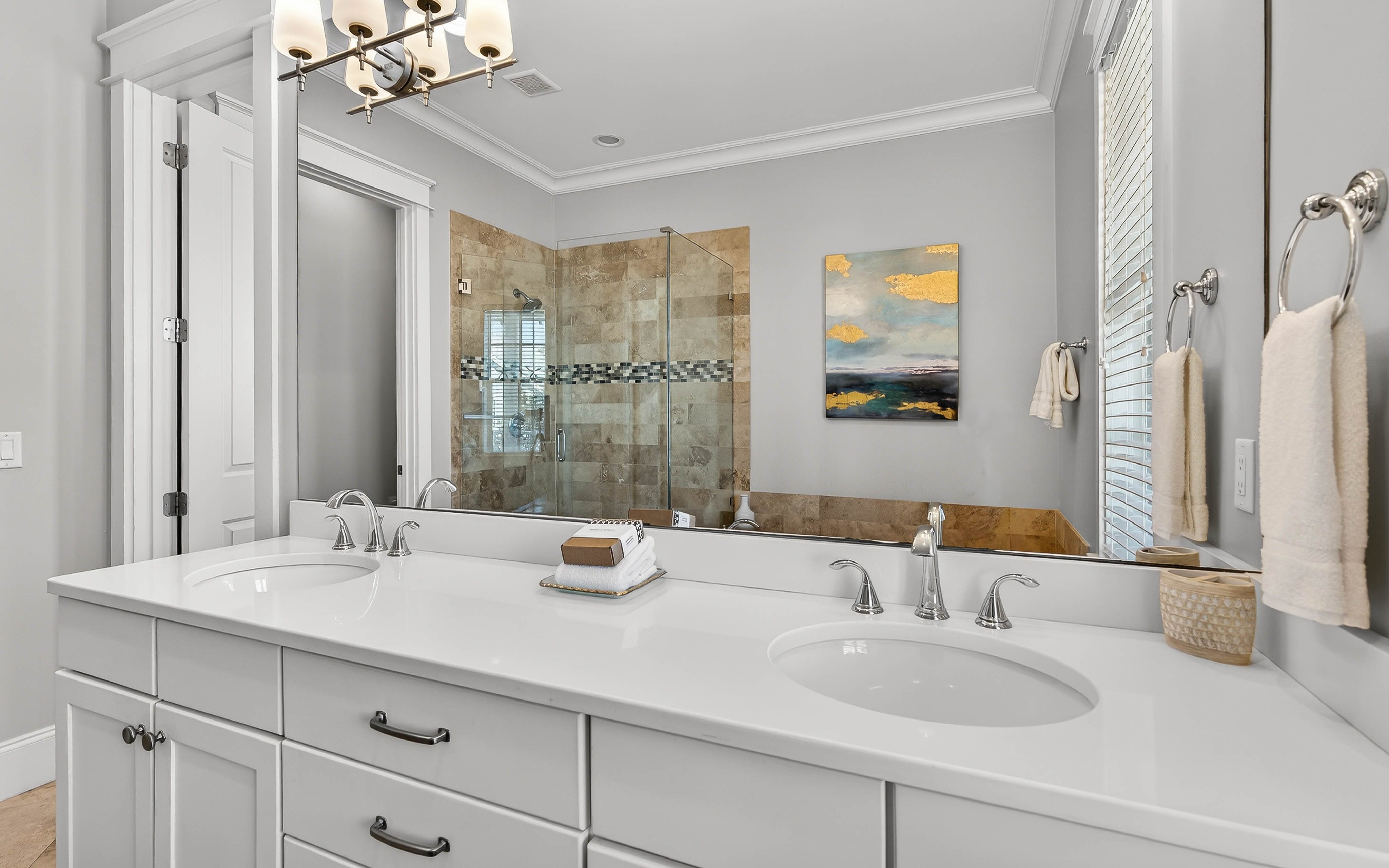 Unwind in your elegant spa-like bathroom with marble countertops, dual vanities, and a luxurious walk-in shower.