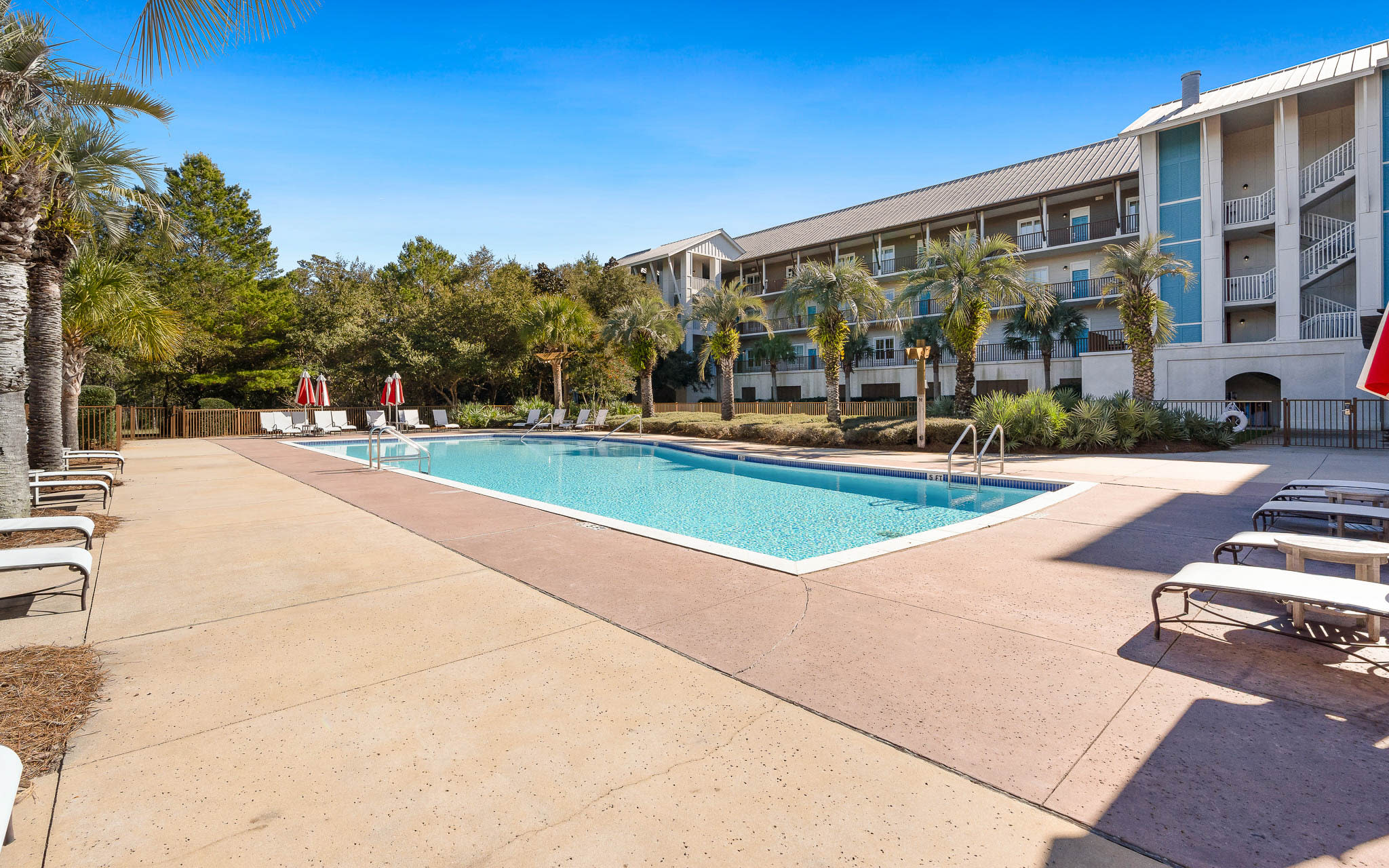 Your home away from home overlooks this sparkling pool where warm days blend into peaceful evenings under swaying palms.