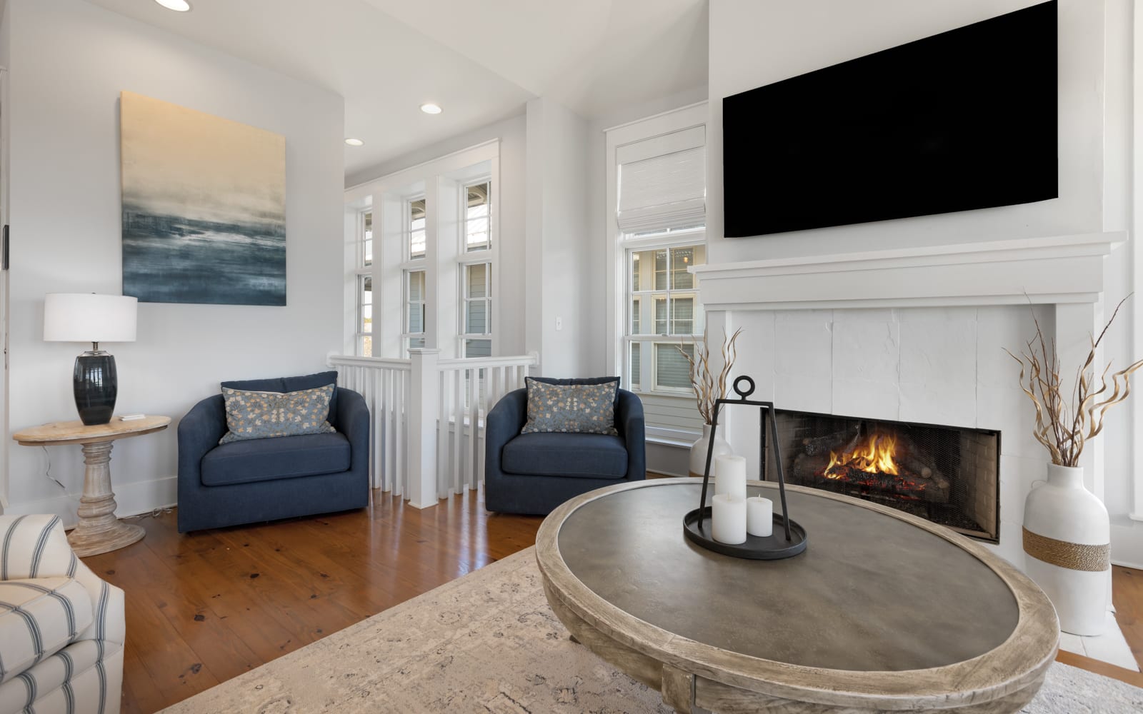 Unwind in your elegant living space with a cozy fireplace, plush seating, and entertainment center for perfect evening relaxation.