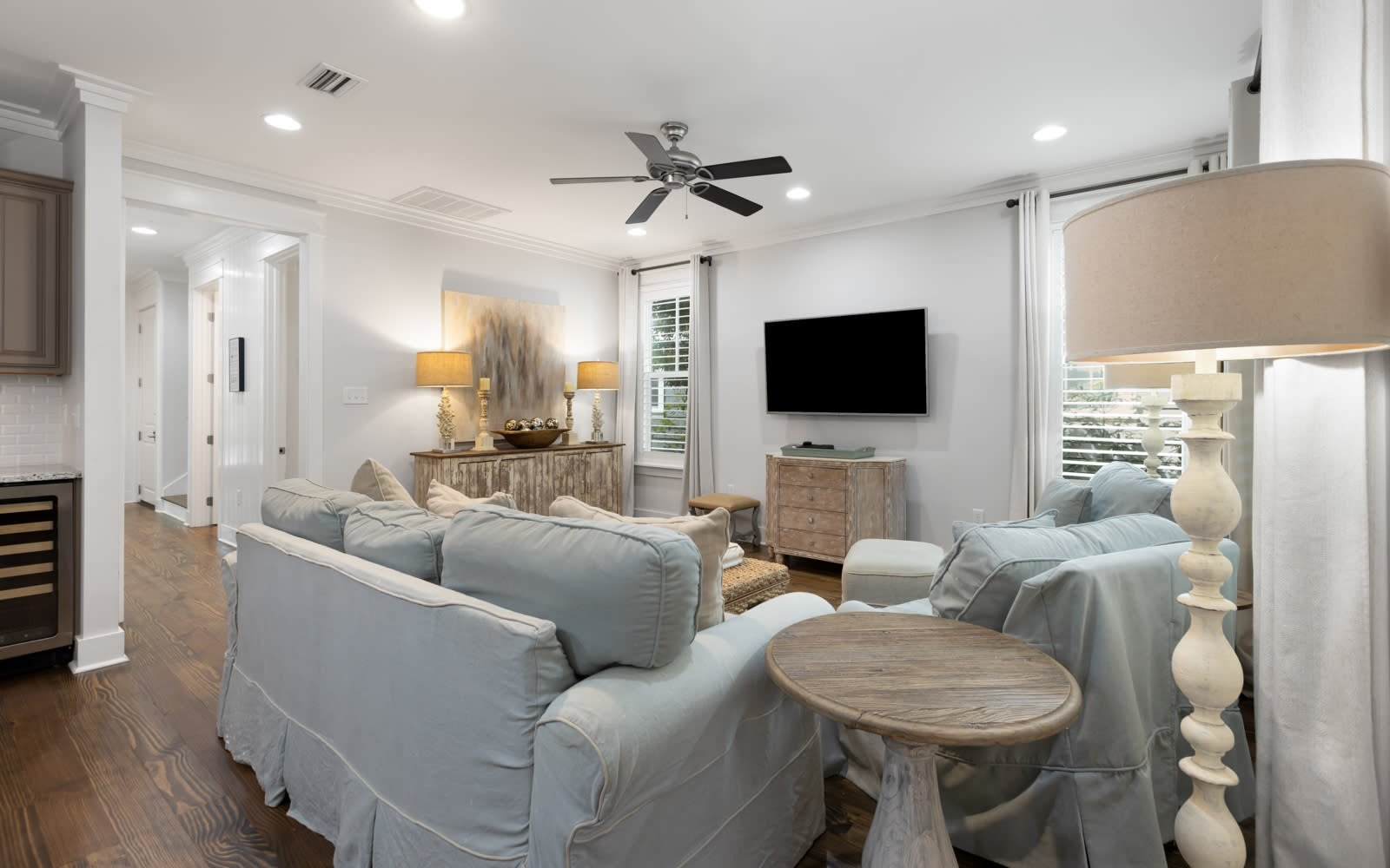 Relax in your elegant living space with plush seating, warm lighting, and coastal-inspired décor creating the perfect atmosphere for unwinding.
