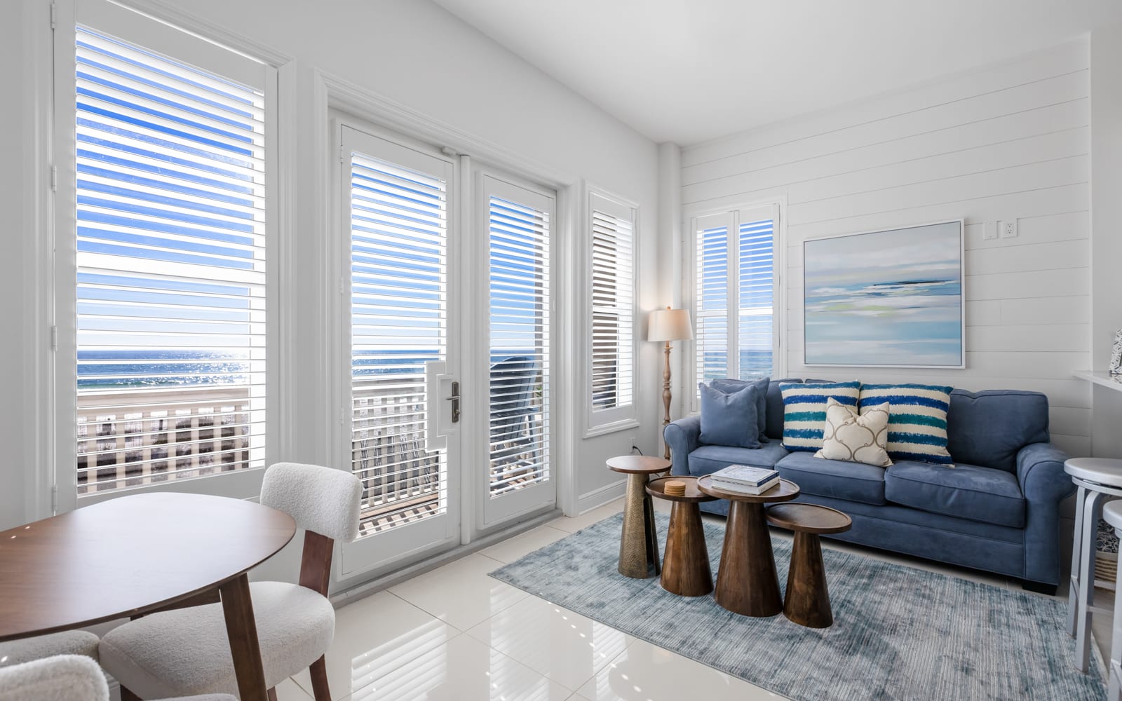 Relax in this bright living room where ocean breezes flow through your private balcony doors, creating the perfect coastal retreat.