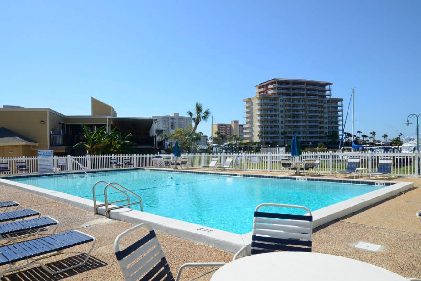 Spacious community pool at Sandpiper Cove Resort with plenty of lounge seating, open views, and a relaxing atmosphere—perfect for cooling off and enjoying sunny Destin days.