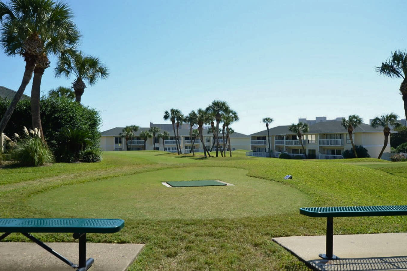 On-site Par-3 golf course at Sandpiper Cove Resort, offering a relaxed setting to practice your short game while enjoying sunny skies and lush coastal surroundings.