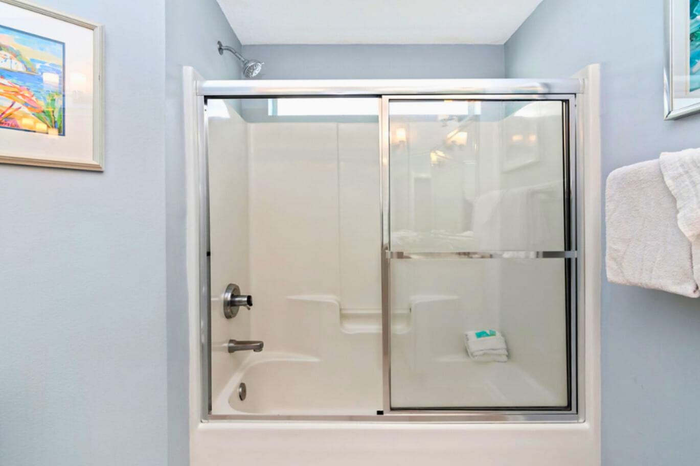 Unwind in your private bathroom with a spacious tub-shower combo and calming blue walls that create a spa-like retreat.