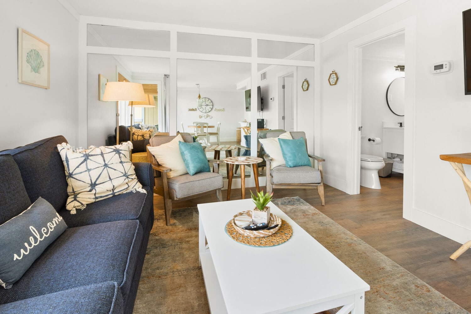 Relax in your bright, coastal-inspired living space with comfy seating, nautical touches, and an open layout perfect for unwinding.