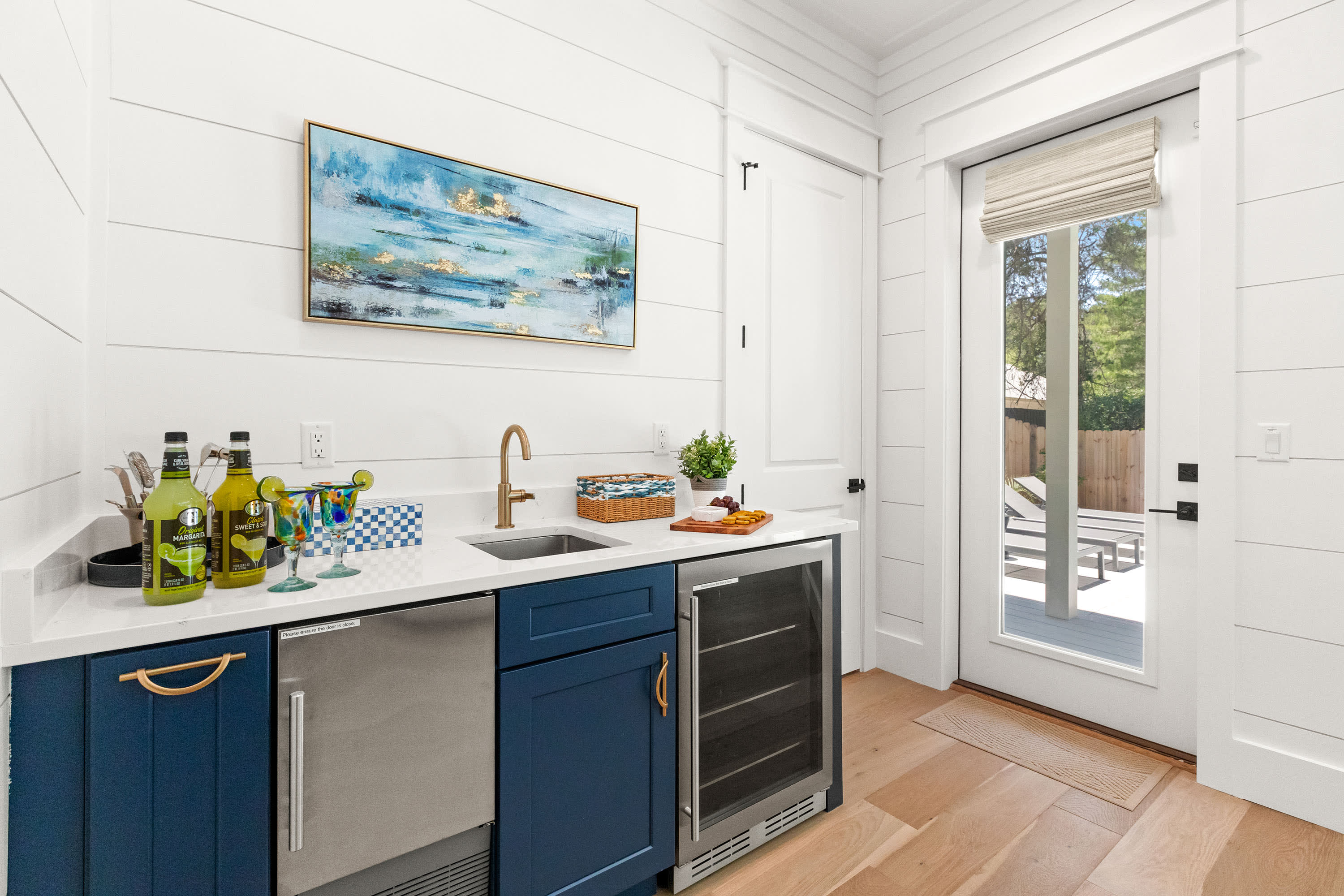 Wet bar with ice maker and mini-fridge. Perfect for pool snacks