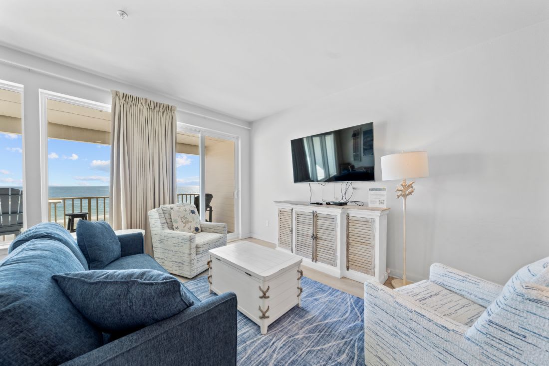 Relax in your bright living room with ocean views streaming through floor-to-ceiling windows. Sink into plush seating while enjoying coastal breezes from your private balcony.
