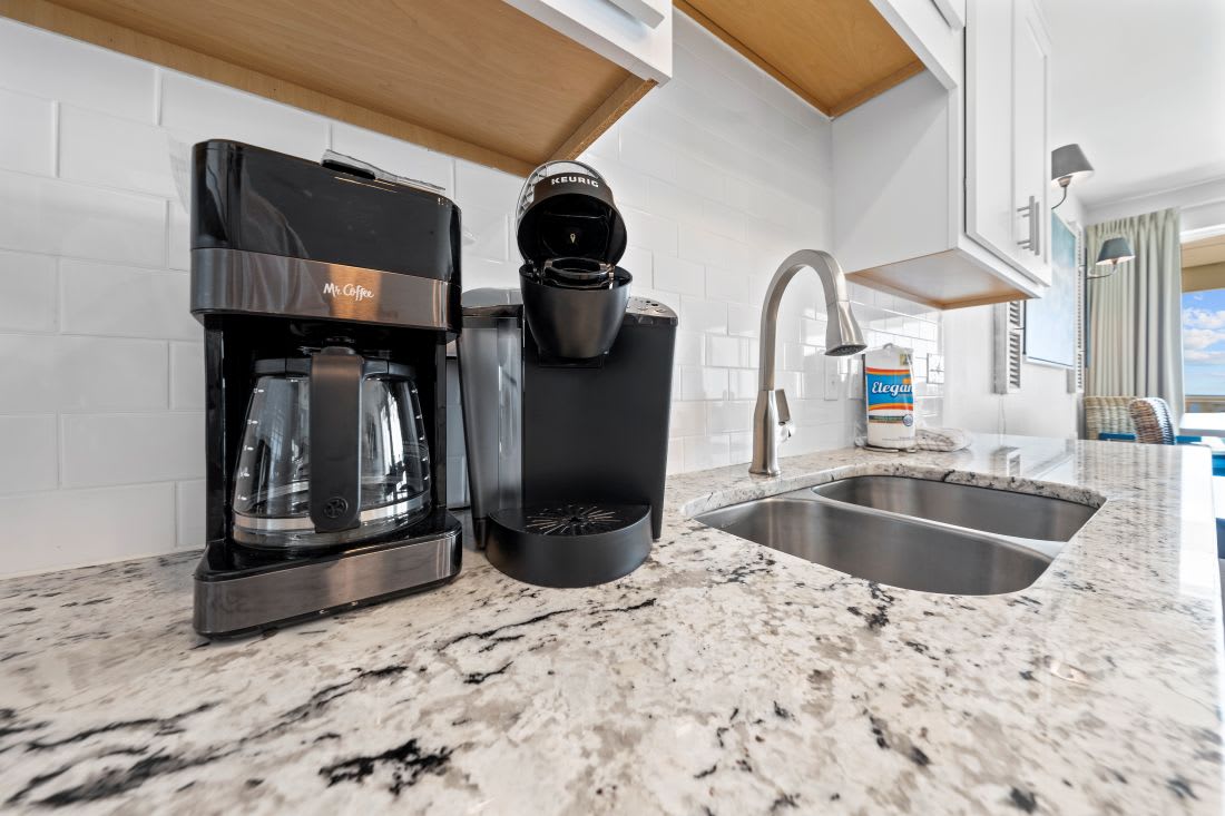 Start your mornings right with premium coffee makers and Keurig at your fingertips in this beautiful granite kitchen.