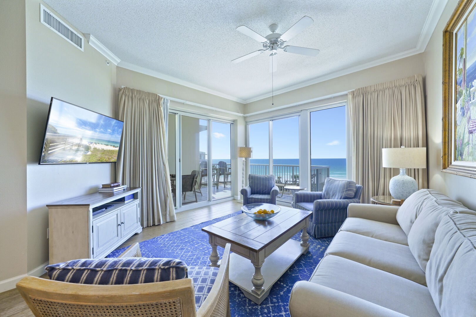 Elegant beachfront living space with floor-to-ceiling windows overlooking the Gulf. Welcome to Crescent 411