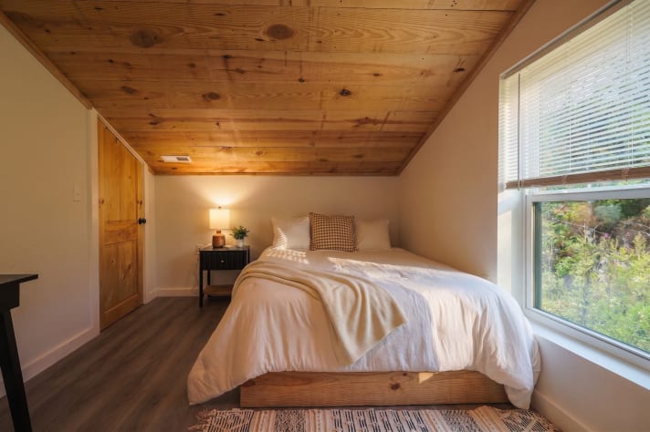 Bedroom with vaulted pine ceiling and forest views from the pillow. Douglas Lake, Tennessee Cabin Rental - Gallery Image #34