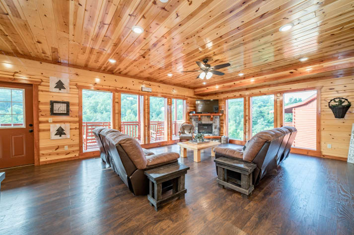 Living room area with fireplace and TV. Pigeon Forge, Tennessee Cabin Rental - Gallery Image #11
