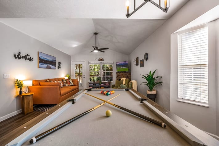 This cozy game room features a full-size pool table, comfy seating, and a fireplace—perfect… Pigeon Forge, Tennessee Cabin Rental - Gallery Image #5