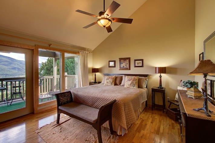 Third Floor King Bedroom with door to front balcony,. Mountain/waterfall view. Pigeon Forge, Tennessee Lodge Rental - Gallery Image #34