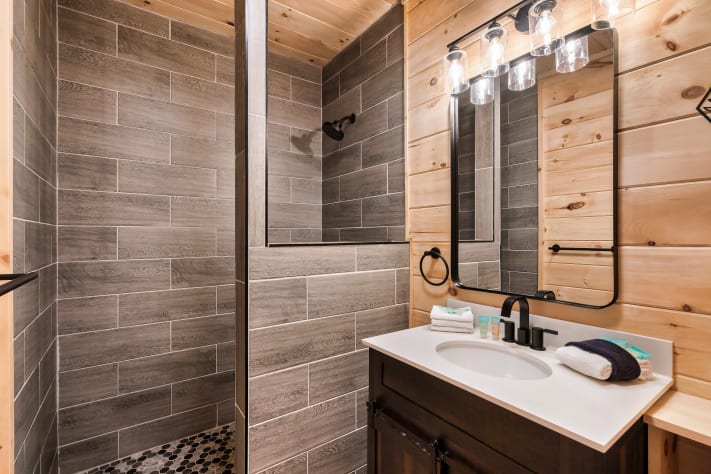 Modern ensuite bathroom featuring a spacious rain shower and plenty of room to get… Sevierville, Tennessee Cabin Rental - Gallery Image #25