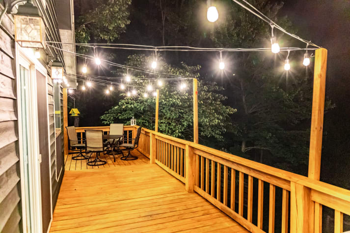 The back patio at night. Check out those lights! Pigeon Forge, Tennessee Cabin Rental - Gallery Image #20