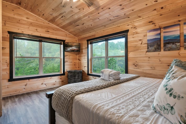 The third king suite features a soaking tub with an overhead shower, creating a… Sevierville, Tennessee Cabin Rental - Gallery Image #22