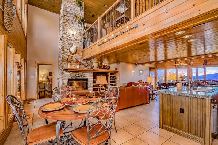 Great Room breakfast/game table, living area, and gourmet kitchen. Pigeon Forge, Tennessee Lodge Rental - Gallery Image #13