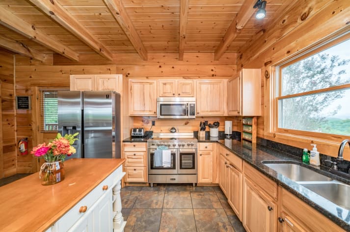Kitchen sink, fridge, and stove. Pigeon Forge, Tennessee Cabin Rental - Gallery Image #18
