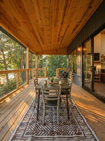 Lakeside porch dining — the table most groups end up using for every meal of the… Douglas Lake, Tennessee Cabin Rental - Gallery Image #13