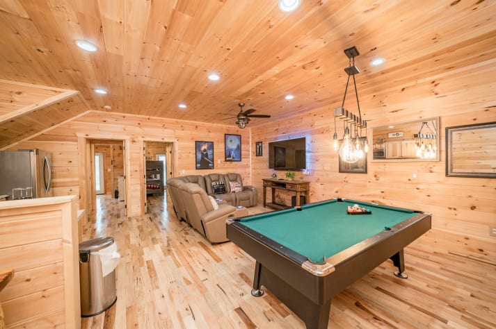 Pool table and living area in basement Pigeon Forge, Tennessee Cabin Rental - Gallery Image #27