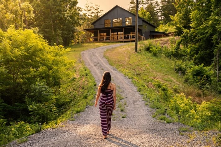 Private gravel drive up to the barndominium — board-and-batten exterior, wrap-around… Douglas Lake, Tennessee Cabin Rental - Gallery Image #2