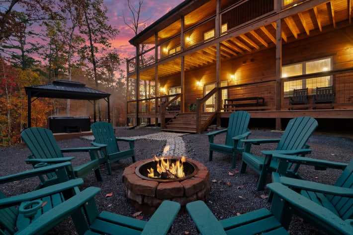 Adirondack chairs circle the fire pit as the Smoky Mountain sky turns pink behind… Sevierville, Tennessee Cabin Rental - Gallery Image #33