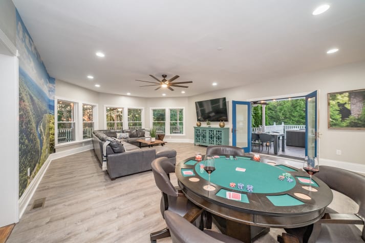 The living room has a large TV and poker table Sevierville, Tennessee Cabin Rental - Gallery Image #31