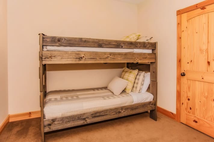 Bedroom with bunk beds and crib connects to master bathroom Pigeon Forge, Tennessee Cabin Rental - Gallery Image #24