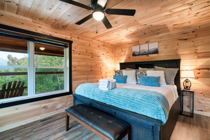 Relax in this second-floor king bedroom, with mountain-view windows, full length… Sevierville, Tennessee Cabin Rental - Gallery Image #21